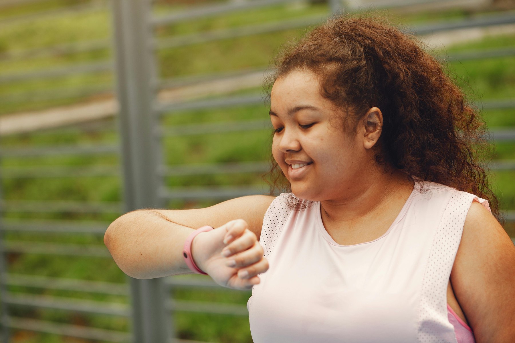 Consumer reviewing health metrics on a smartwatch outdoors